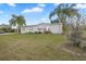 Single-wide mobile home with palm trees and landscaping at 19990 E State Road 64, Bradenton, FL 34212