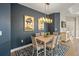 Elegant dining room with a stylish light fixture and blue accent wall at 200 Altamura Cir, Nokomis, FL 34275