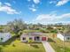 Single-story home with red garage door and canal view at 20096 Tappan Zee Dr, Port Charlotte, FL 33952
