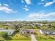 Single-story home with red garage door and canal view at 20096 Tappan Zee Dr, Port Charlotte, FL 33952