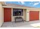 House entrance with red door and bench at 20096 Tappan Zee Dr, Port Charlotte, FL 33952