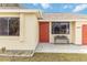 House entrance with red door and bench at 20096 Tappan Zee Dr, Port Charlotte, FL 33952