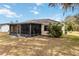 Ranch-style home with screened patio and well-maintained lawn at 20096 Tappan Zee Dr, Port Charlotte, FL 33952
