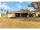 Single-story home with screened porch and yard at 20096 Tappan Zee Dr, Port Charlotte, FL 33952
