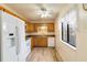 Galley kitchen with white appliances and wood cabinets at 20096 Tappan Zee Dr, Port Charlotte, FL 33952