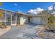 Inviting home with a driveway leading to the garage and a decorative stone garden at 217 46Th W St, Bradenton, FL 34209