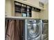 Modern laundry room with front-loading washer and dryer, offering convenient functionality and ample storage at 217 46Th W St, Bradenton, FL 34209