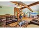 Open-concept living room with wood floors, a cozy fireplace, and a comfortable leather couch at 217 46Th W St, Bradenton, FL 34209