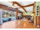 Inviting living area with wood floors, exposed beams, and access to the outdoor pool area at 217 46Th W St, Bradenton, FL 34209