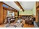 Comfortable living room featuring wood floors, exposed beams, and a stylish area rug at 217 46Th W St, Bradenton, FL 34209