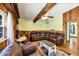 Spacious living room with a large leather sectional, wood floors, and exposed ceiling beams at 217 46Th W St, Bradenton, FL 34209