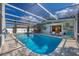 Stunning pool with a screened-in enclosure, bar, and inviting seating, perfect for relaxation and entertainment at 217 46Th W St, Bradenton, FL 34209