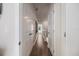 Bright hallway with hardwood floors and multiple doors leading to bedrooms at 2462 Mangum Ct, Sarasota, FL 34237