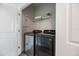 Laundry room with washer, dryer, and shelving at 2462 Mangum Ct, Sarasota, FL 34237