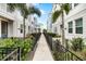 Neat walkway between townhomes with lush landscaping at 2462 Mangum Ct, Sarasota, FL 34237