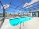 Inviting pool area with screened enclosure, offering water views at 2468 Quail Ter, Port Charlotte, FL 33981