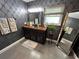Elegant bathroom with a dark vanity and patterned wallpaper at 2502 Alpine Ave, Sarasota, FL 34239