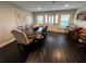 Formal dining room with a large table, piano, and hardwood floors at 2502 Alpine Ave, Sarasota, FL 34239