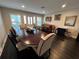 Formal dining room features oval table, hardwood floors, and a classic piano at 2502 Alpine Ave, Sarasota, FL 34239