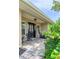 Inviting front porch with tile flooring and black door at 2502 Alpine Ave, Sarasota, FL 34239