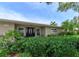 Landscaped front yard with lush green shrubs and trees at 2502 Alpine Ave, Sarasota, FL 34239