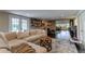 Open concept Gathering room with sectional sofa, hardwood floors, and French doors leading outside at 2502 Alpine Ave, Sarasota, FL 34239