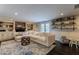 Spacious Gathering room boasts a large sectional sofa, built-in shelving, and fireplace at 2502 Alpine Ave, Sarasota, FL 34239