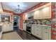 Stylish kitchen with white cabinets, dark floors, and patterned wallpaper at 2502 Alpine Ave, Sarasota, FL 34239