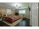Spacious main bedroom with dark hardwood floors, and a relaxing sitting area at 2502 Alpine Ave, Sarasota, FL 34239