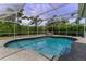 Inviting kidney-shaped pool with covered patio at 2502 Alpine Ave, Sarasota, FL 34239