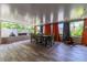 Bright sunroom with tile floors, dining table, and orange curtains at 2502 Alpine Ave, Sarasota, FL 34239