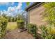 Landscaped backyard with a screened enclosure and patio at 26954 Pavin Dr, Englewood, FL 34223