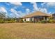Spacious backyard showcasing a large patio and screened enclosure at 26954 Pavin Dr, Englewood, FL 34223