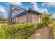 Screened patio with lush landscaping and a spacious backyard at 26954 Pavin Dr, Englewood, FL 34223