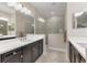 Elegant bathroom with a double vanity and large walk-in shower at 26954 Pavin Dr, Englewood, FL 34223