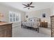 Spacious bedroom with large bed, nightstands, and window with shutters at 26954 Pavin Dr, Englewood, FL 34223