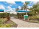 Entrance to resort-style pool with lush landscaping and shaded seating at 26954 Pavin Dr, Englewood, FL 34223