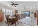 Spacious dining area with wooden table and access to the living room at 26954 Pavin Dr, Englewood, FL 34223