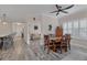 Bright dining room with wooden table and chairs near living room at 26954 Pavin Dr, Englewood, FL 34223