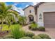 Front entry of home with walkway and landscaping at 26954 Pavin Dr, Englewood, FL 34223