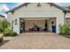 Two-car garage with ample storage space and an open door at 26954 Pavin Dr, Englewood, FL 34223
