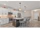 Modern kitchen with island, white cabinets, and stainless steel appliances at 26954 Pavin Dr, Englewood, FL 34223