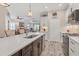 Kitchen with island, white cabinets, and stainless steel appliances at 26954 Pavin Dr, Englewood, FL 34223