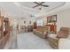 Living room with sectional sofa, hardwood floors, and large windows at 26954 Pavin Dr, Englewood, FL 34223