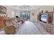 Spacious living room with large sectional sofa and built-in entertainment center at 26954 Pavin Dr, Englewood, FL 34223