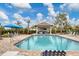 Relaxing community pool with shaded seating and a grilling station at 26954 Pavin Dr, Englewood, FL 34223