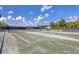 Tennis courts with shaded seating area at 26954 Pavin Dr, Englewood, FL 34223