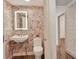 Charming powder room with floral wallpaper and a pedestal sink at 3060 Grand Bay Blvd # 175, Longboat Key, FL 34228