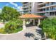 Elegant building entrance with covered walkway, lush landscaping, and inviting atmosphere at 3060 Grand Bay Blvd # 175, Longboat Key, FL 34228