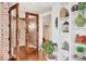 Elegant entryway with brick wall and built-in shelving at 3060 Grand Bay Blvd # 175, Longboat Key, FL 34228